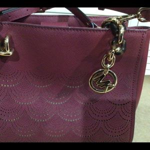 Michael Kors burgandy with gold stencil in front. Like brand new